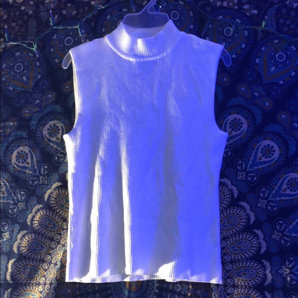 this turtleneck tank is a beige or off-white color